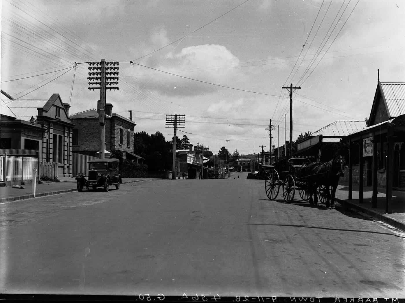 Historic photo of a country town main street lined with shops