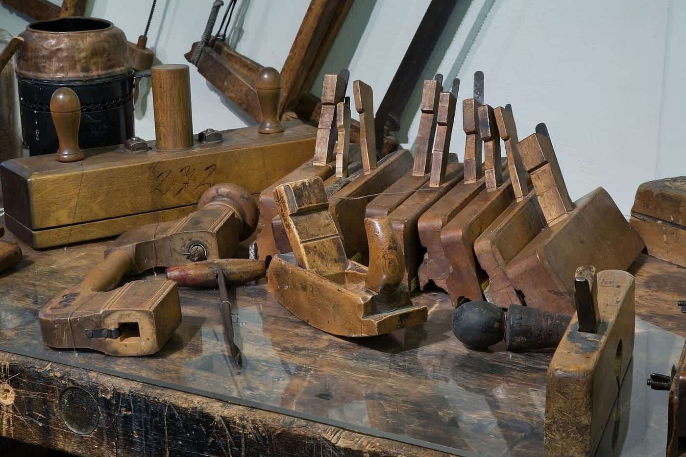 Old woodworking planes and hand tools on a workshop bench